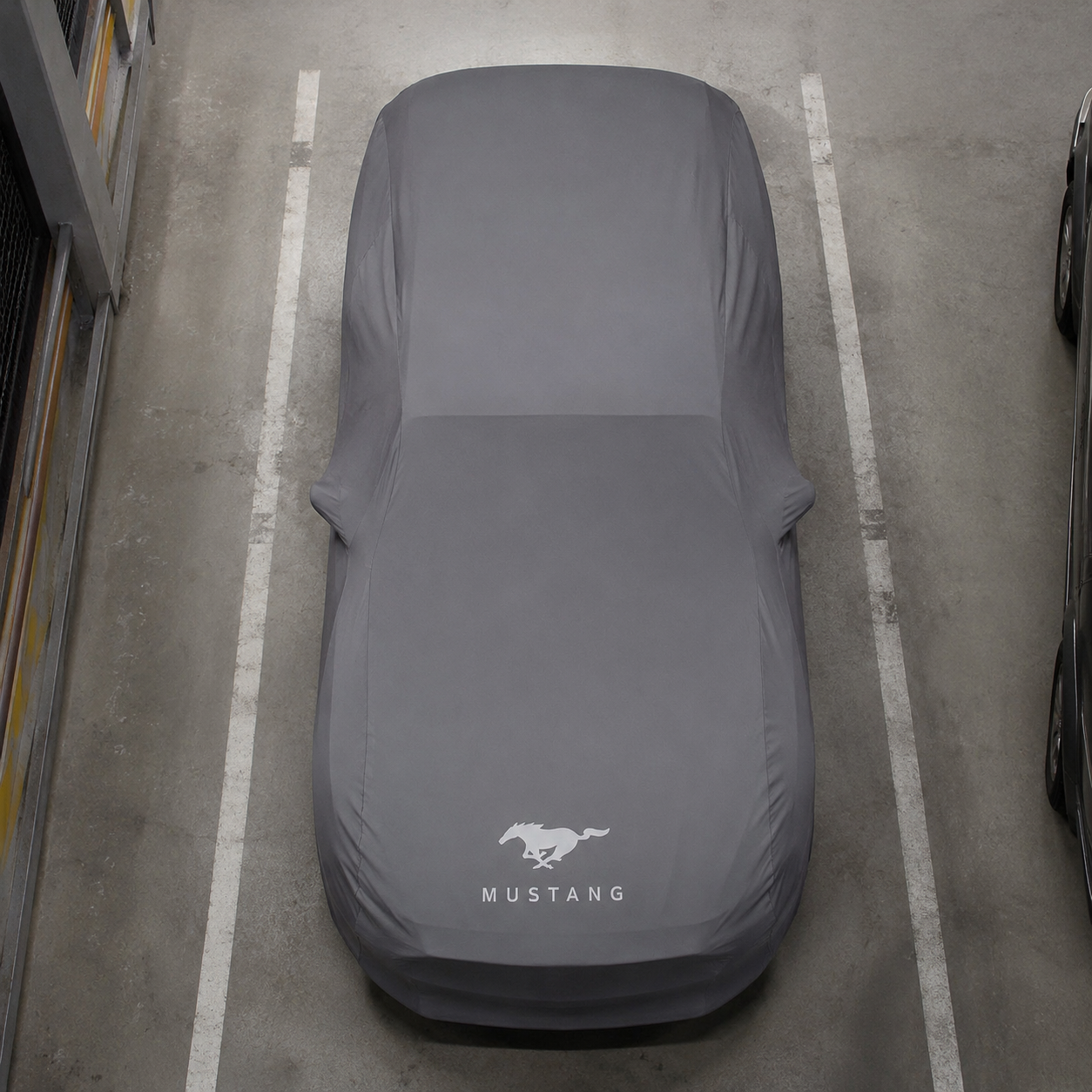 Top view of a Ford Mustang protected by a gray custom-tailored indoor car cover