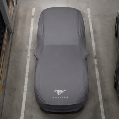 Top view of a Ford Mustang protected by a gray custom-tailored indoor car cover
